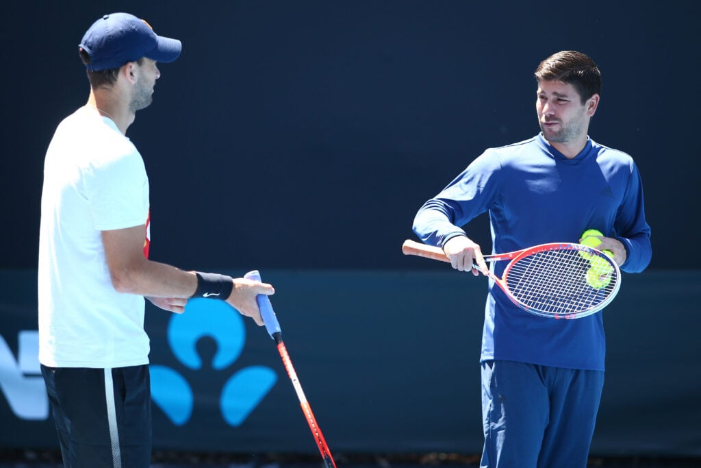 Daniel Vallverdu and Grigor Dimitrov talk at the Australian Open in 2018.
