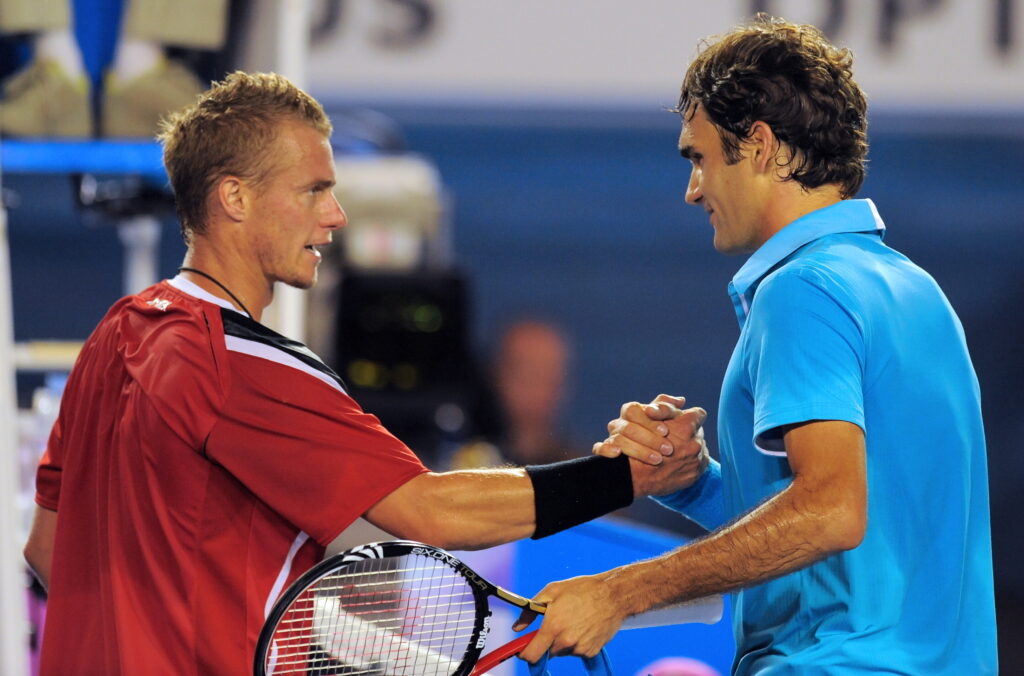 Roger Federer shakes hands with Lleyton Hewitt after their match at the 2010 Australian Open.