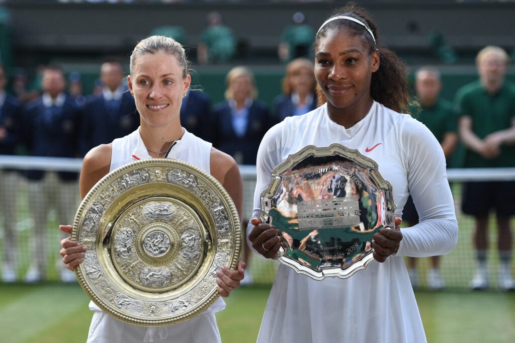 Angelique Kerber and Serena Williams posing with their trophies after the 2018 Wimbledon final.