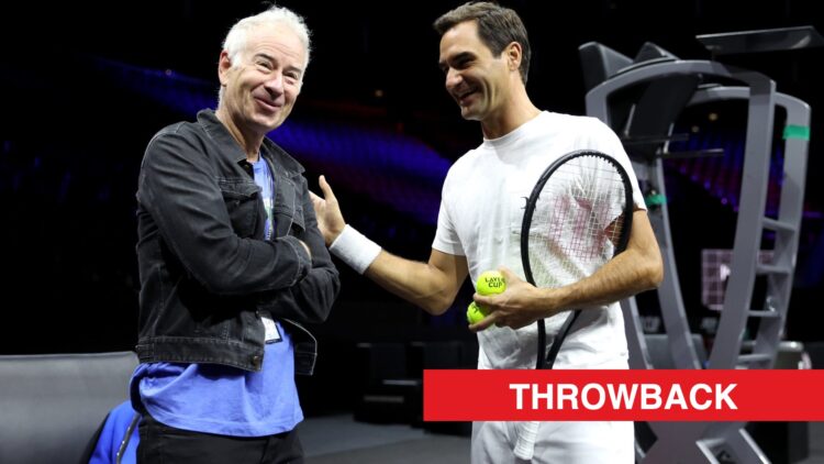 Roger Federer and John McEnroe talking at the 2022 Laver Cup, with a throwback label.