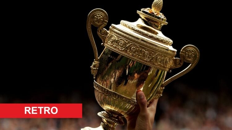 Image of Roger Federer lifting the Wimbledon trophy in the air after winning in 2005