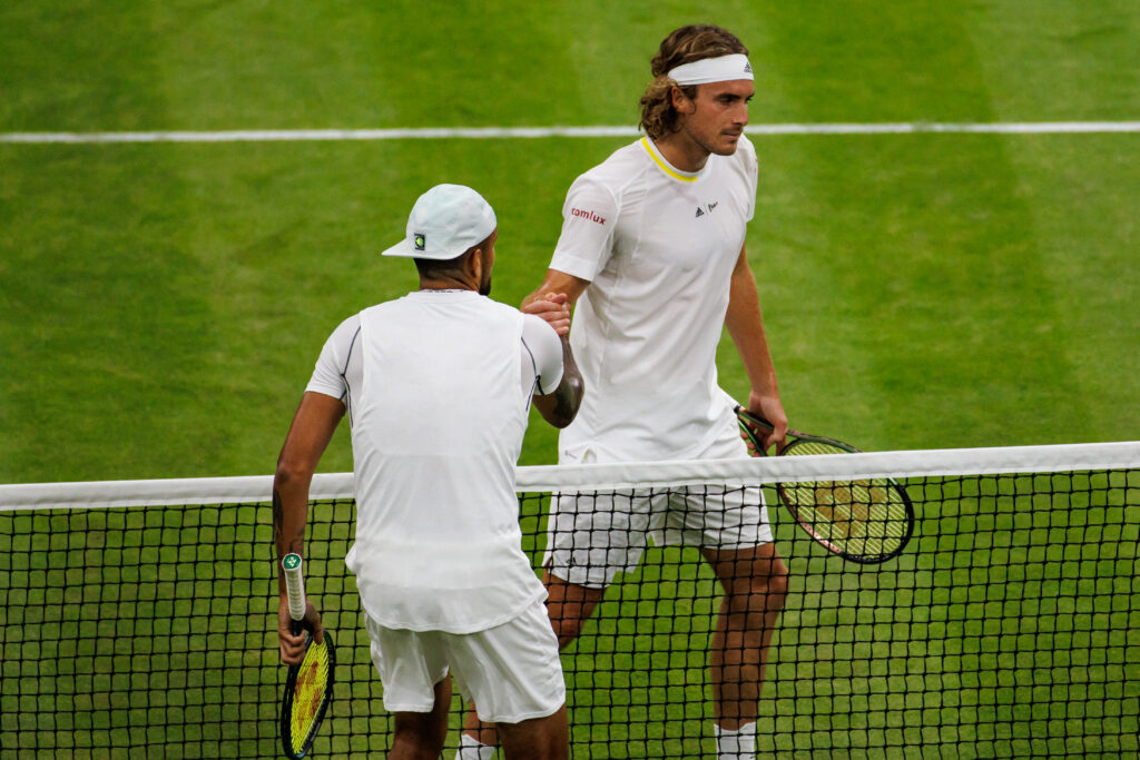 Nick Kyrgios and Stefanos Tsitsipas meet at the net after their match at Wimbledon in 2022