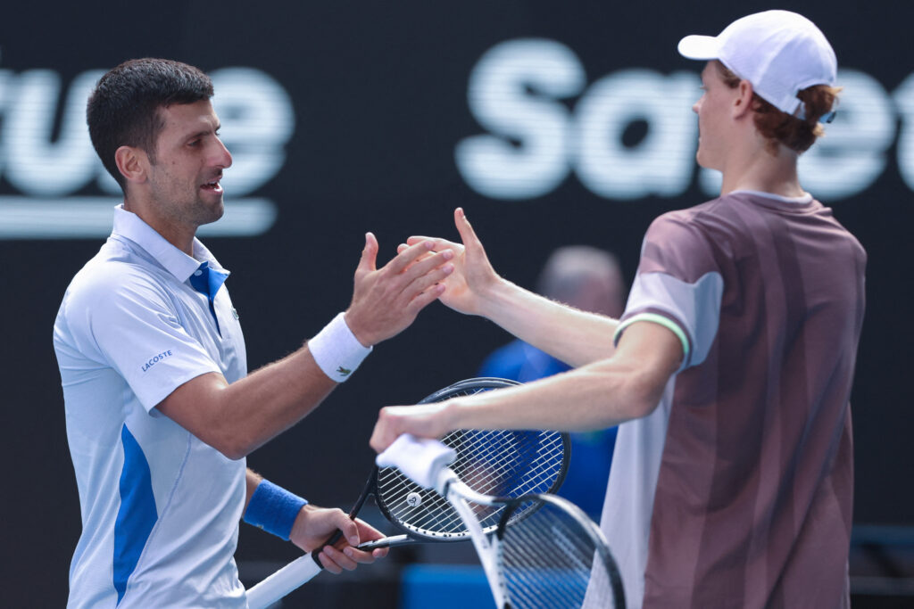 Novak Djokovic and Jannik Sinner shake hands after their semifinal match at the 2024 Australian Open