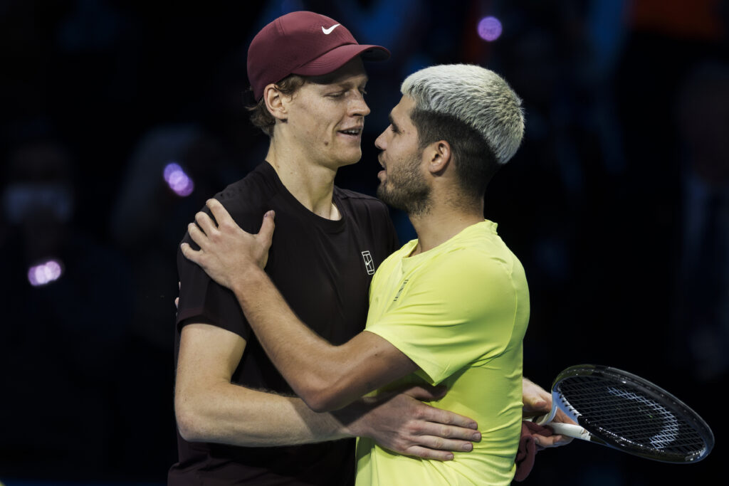 Jannik Sinner and Carlos Alcaraz embrace after their match at the 2025 ATP Finals