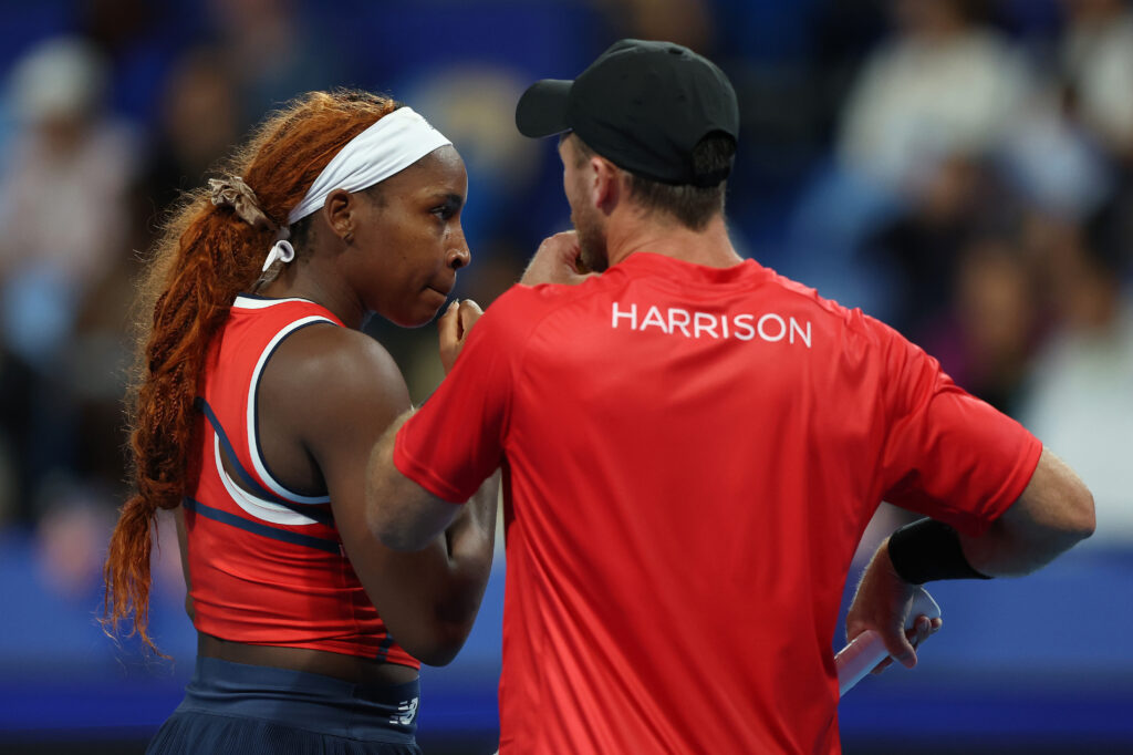 Coco Gauff and Christian Harrison discussing tactics during USA's doubles match against Argentina at the 2026 United Cup.