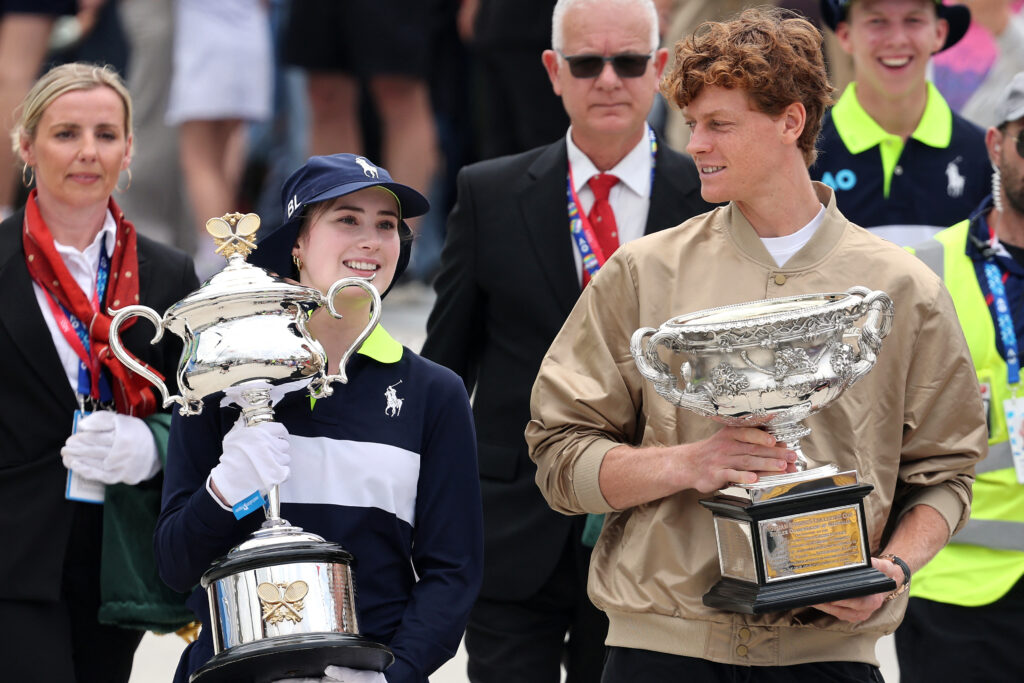Jannik Sinner holds the Australian Open title as he walks to the draw for the 2026 tournament.