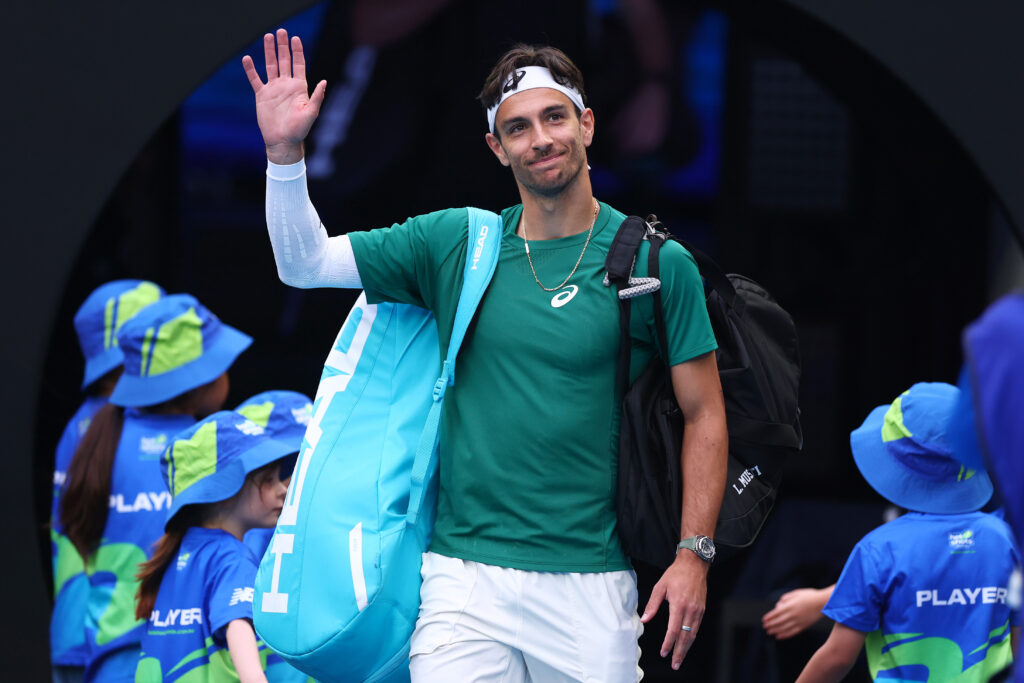 Lorenzo Musetti waves to the crowd ahead of exhibition match vs Alexander Zverev