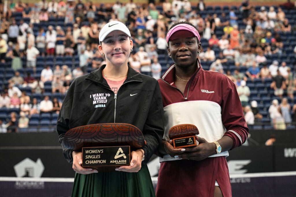 Mirra Andreeva and Victoria Mboko pose with their trophies after the Adelaide International final.