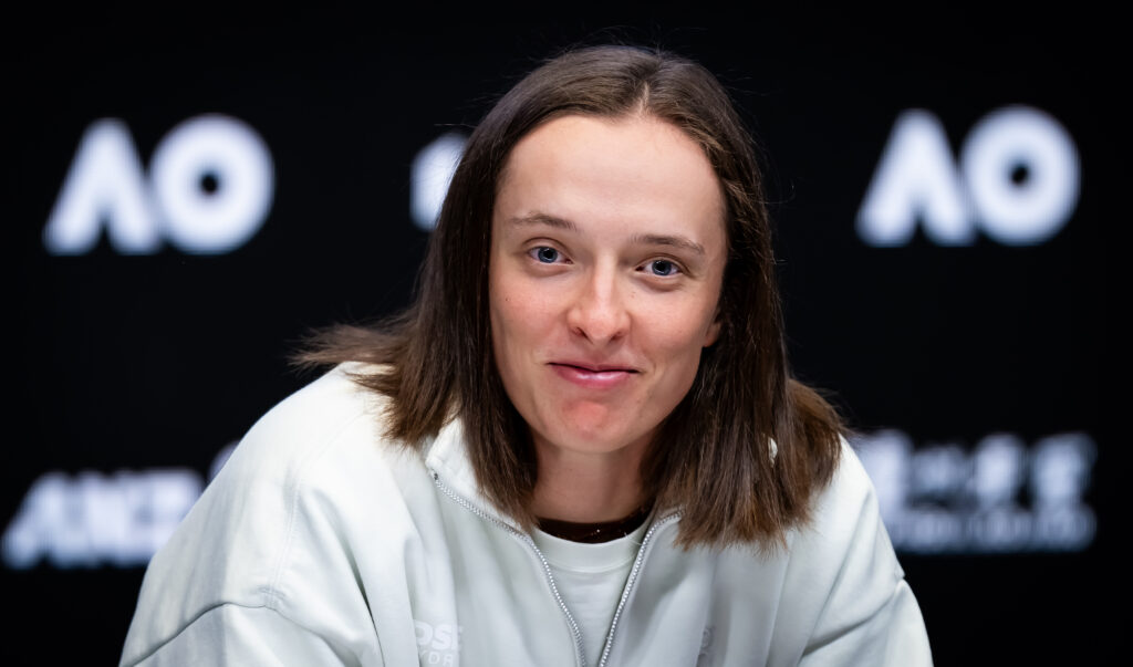 Iga Swiatek smiles at a press conference.