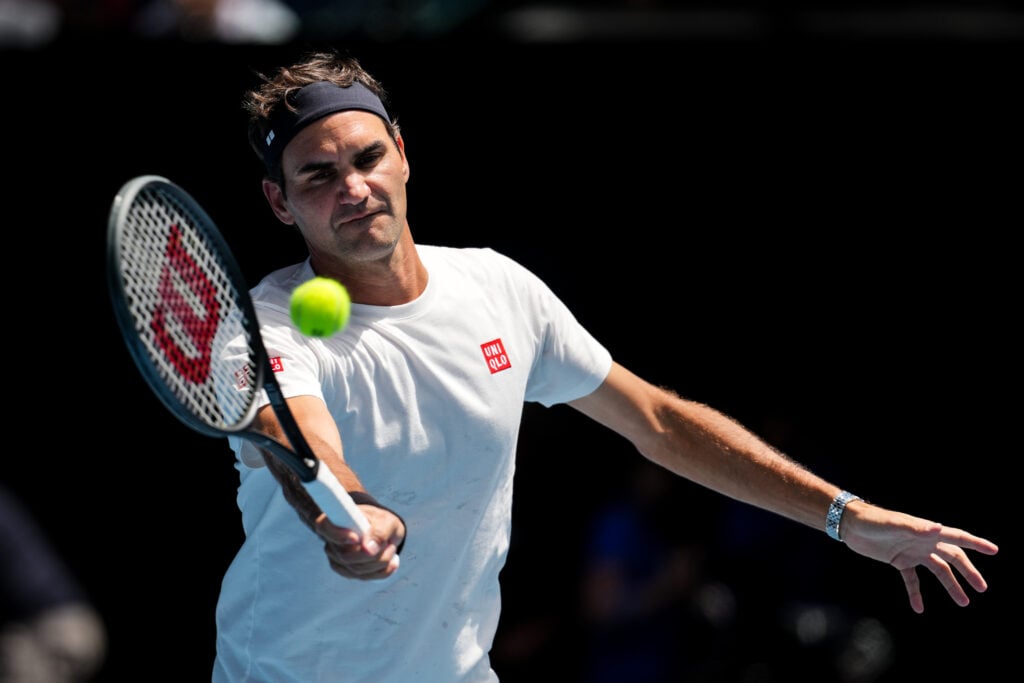 Roger Federer hits a forehand during a practice session with Casper Ruud