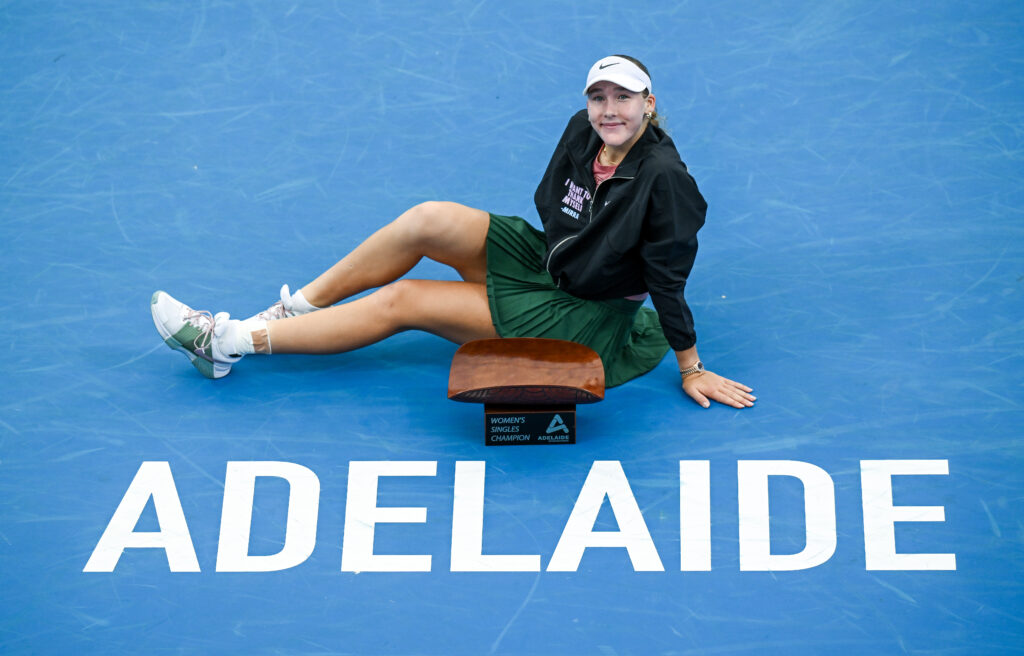 Mirra Andreeva poses with the Adelaide International trophy after beating Victoria Mboko in the 2026 final.