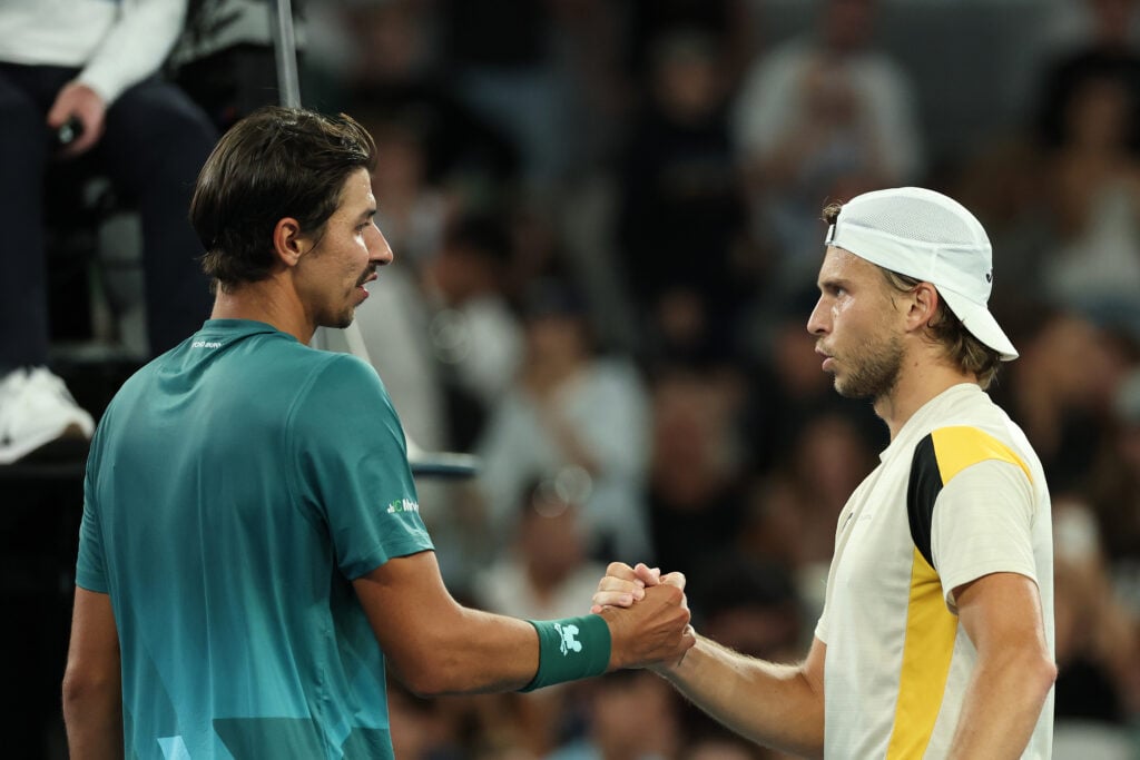 Alexei Popyrin shakes hands with Alexandre Muller after losing his first round match at the 2026 Australian Open.