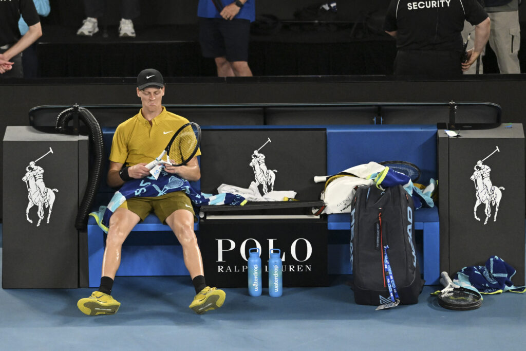 Jannik Sinner sits slumped in his chair