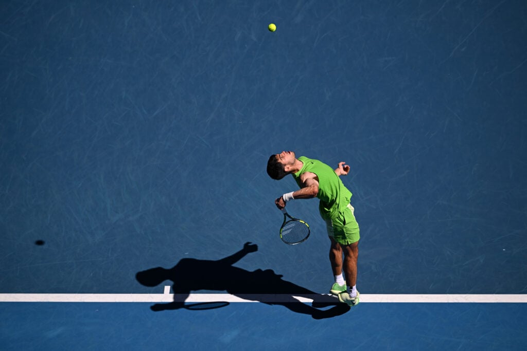 Carlos Alcaraz hits a serve against Yannick Hanfmann at the 2026 Australian Open.