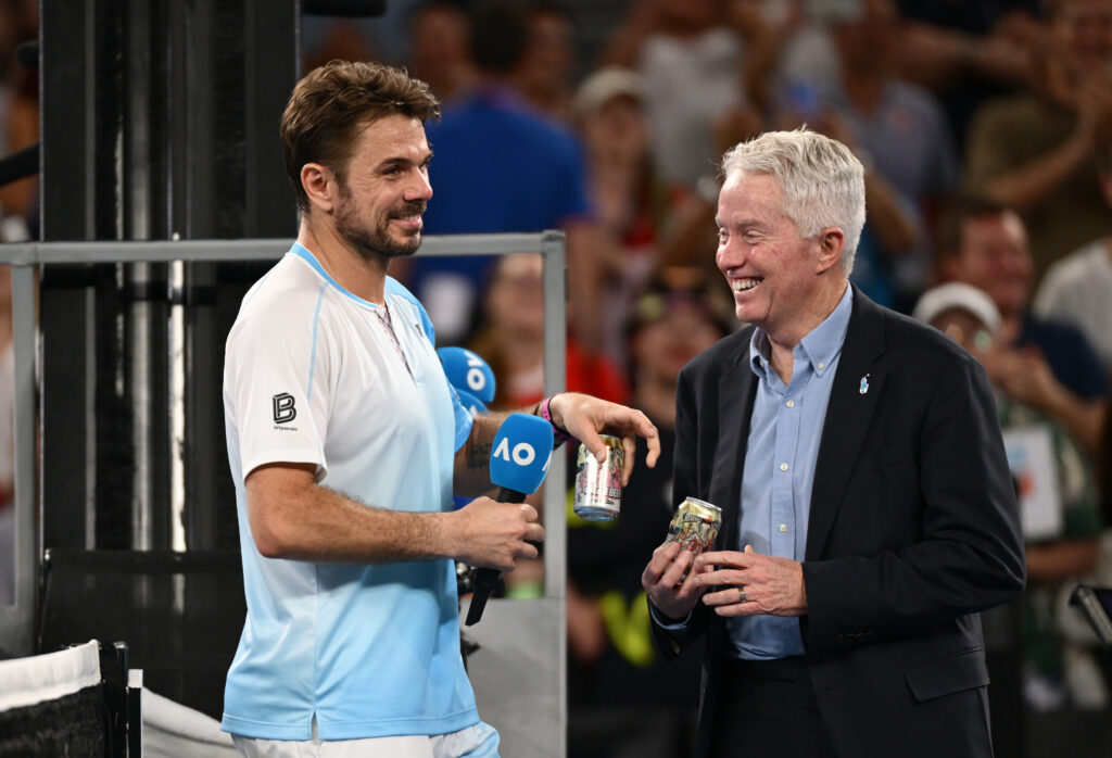Stan Wawrinka shares a beer with Craig Tiley after his final match at the Australian Open