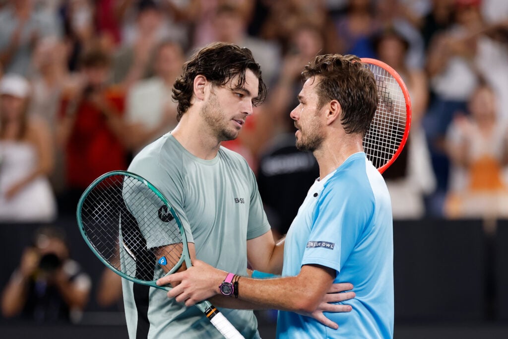 Taylor Fritz and Stan Wawrinka embrace at the net after their match at the 2026 Australian Open