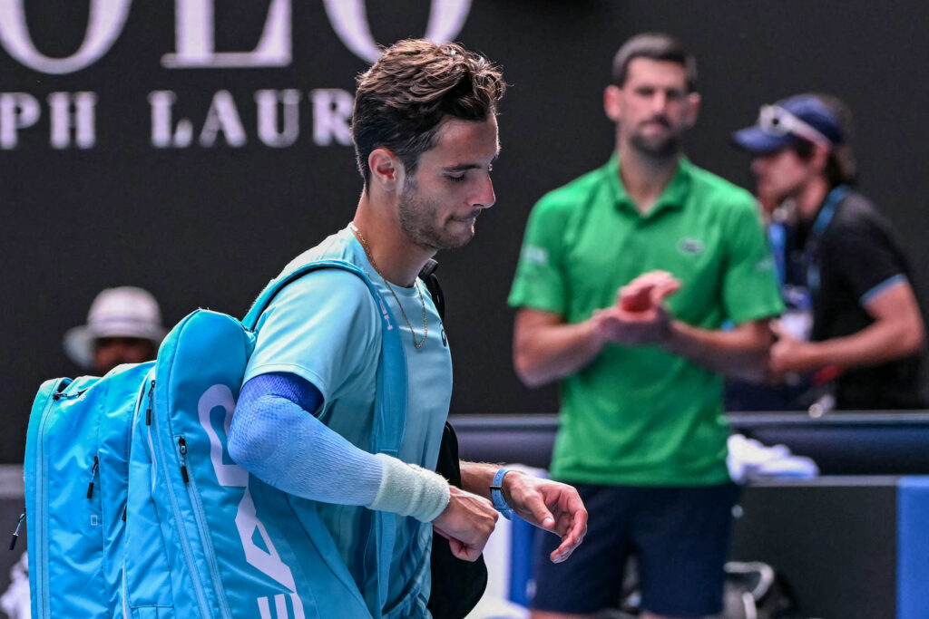 Lorenzo Musetti walks off the court after losing to Novak Djokovic at the 2026 Australian Open