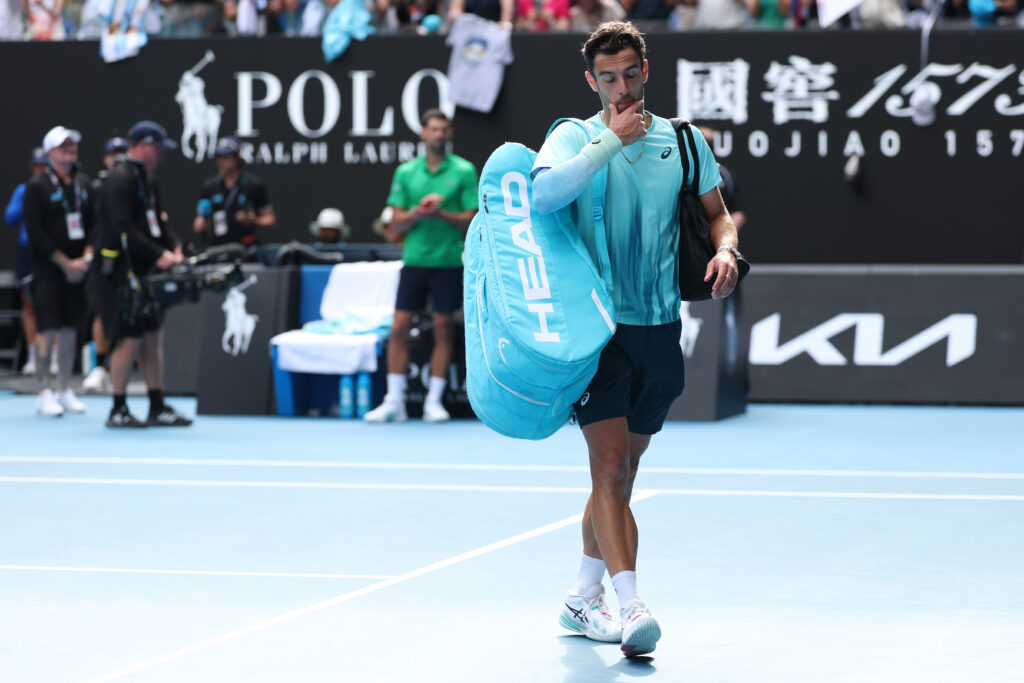 Lorenzo Musetti walks off court