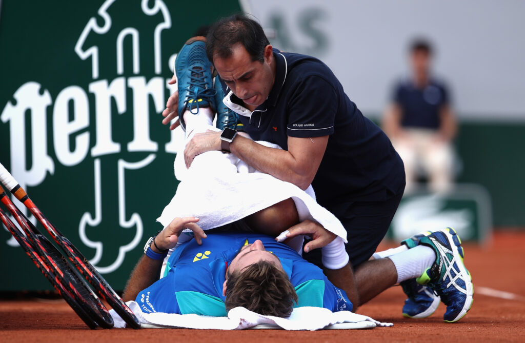 Stan Wawrinka receives treatment for an injury during the 2017 French Open