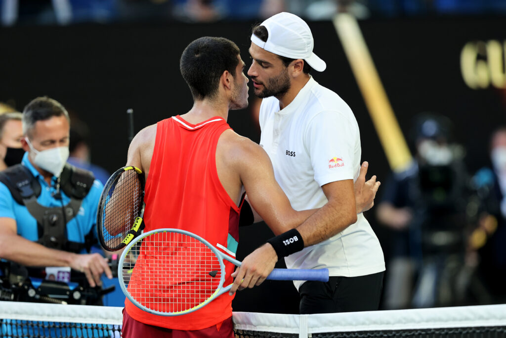 Carlos Alcaraz and Matteo Berrettini embrace after their match at the 2022 Australian Open