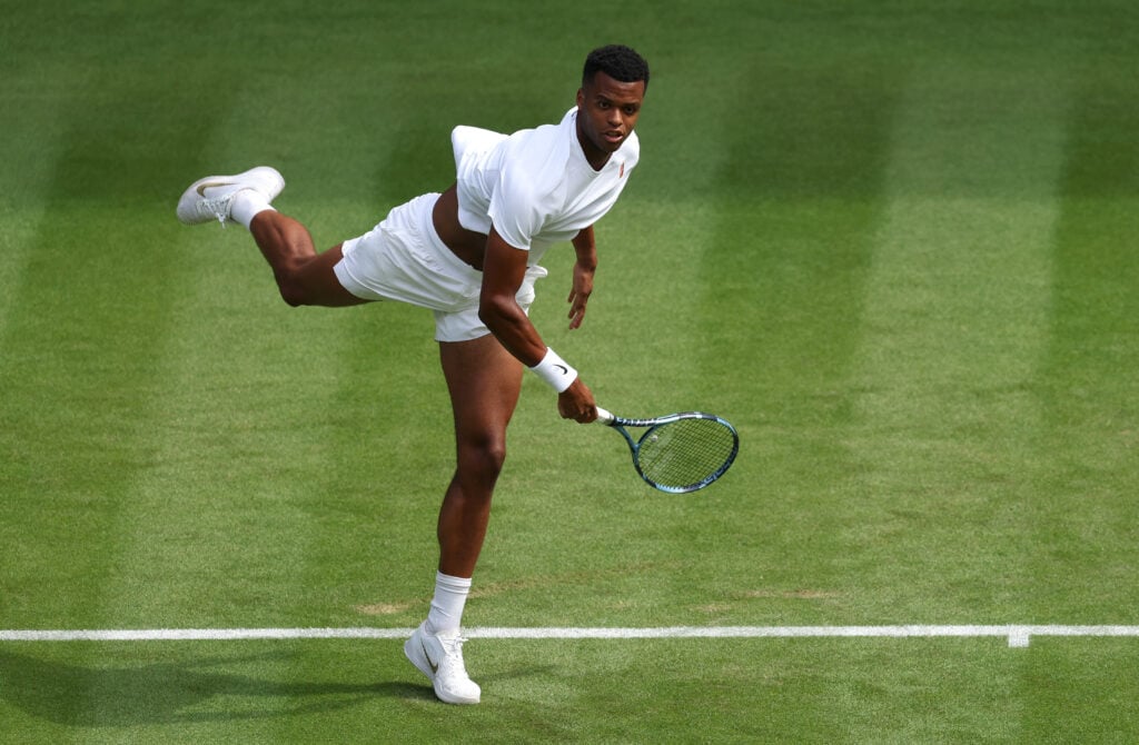 Giovanni Mpetshi Perricard serves against Taylor Fritz at Wimbledon in 2025