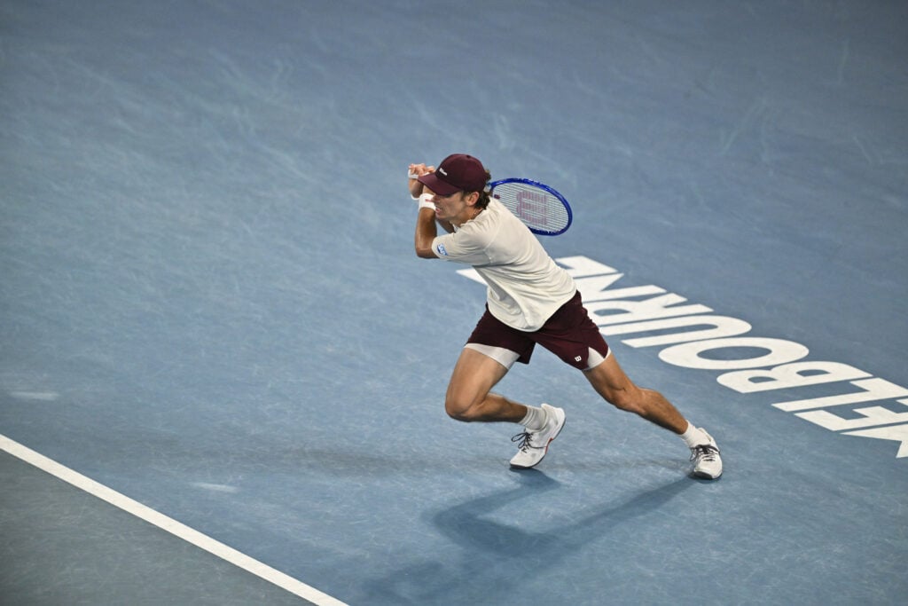 Alex de Minaur hits a shot