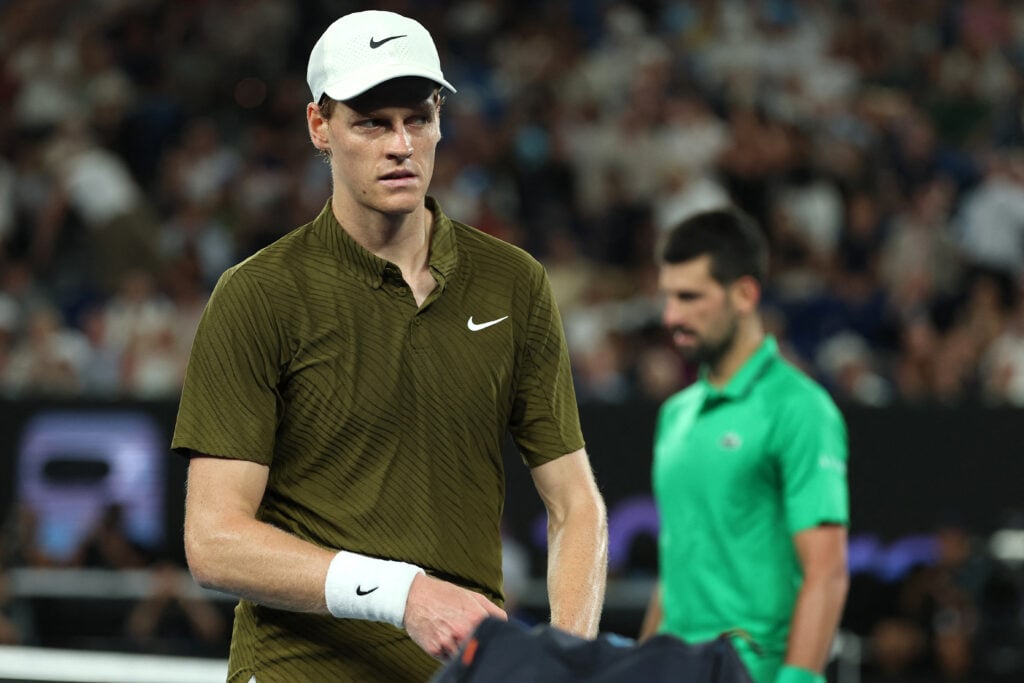 Jannik Sinner looks on as he switches side of course with Novak Djokovic during their semifinal match at the 2026 Australian Open.