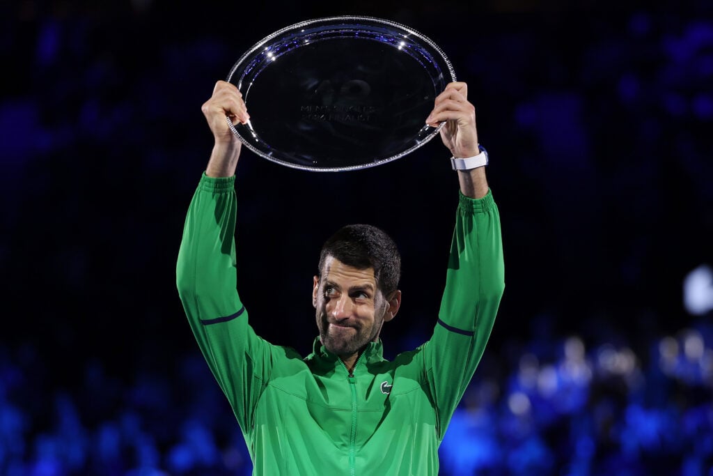 Novak Djokovic holds his runner-up trophy aloft at the Australian Open.