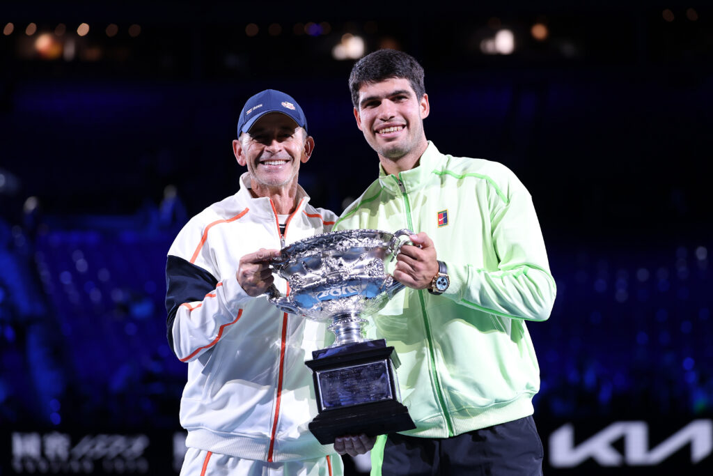Samuel Lopez and Carlos Alcaraz pose with the Australian Open trophy after the 2026 men's singles final.