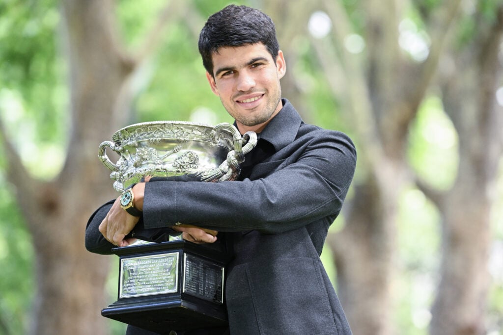 Carlos Alcaraz pictured holding the 2026 Australian Open trophy.