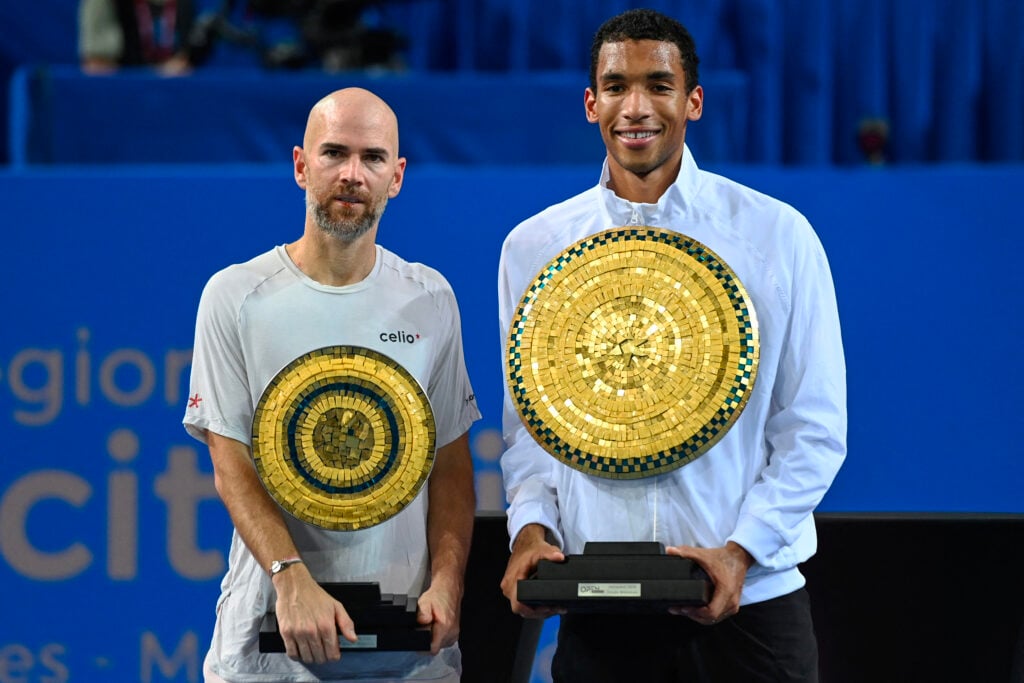 Adrian Mannarino and Felix Auger-Aliassime pose with their respective finals after the 2026 final in Montpellier.