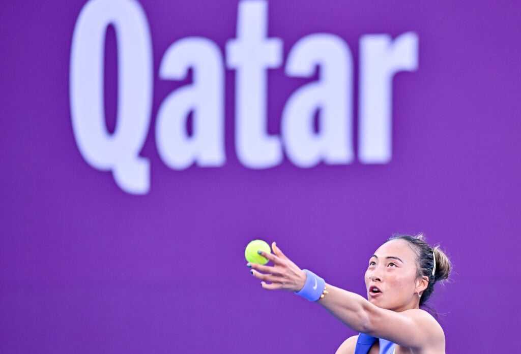 Qinwen Zheng hits a serve against Sofia Kenin at the 2026 Qatar Open.