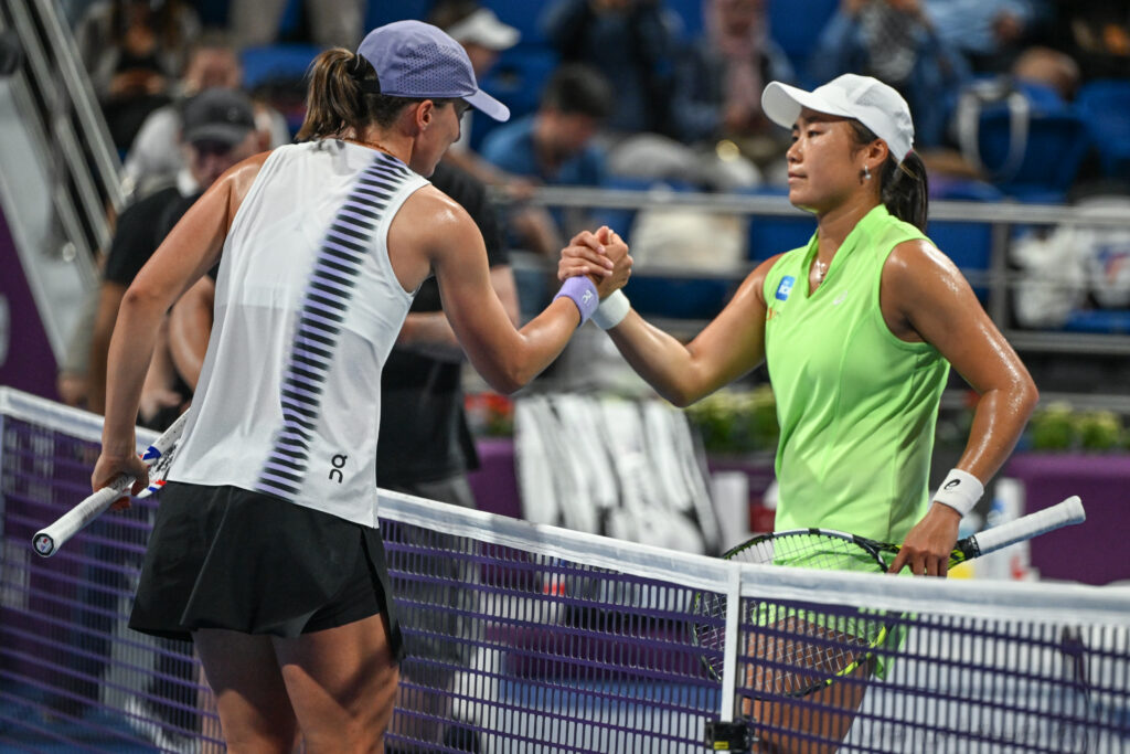 Iga Swiatek and Janice Tjen shake hands after their match at the 2026 Qatar Open