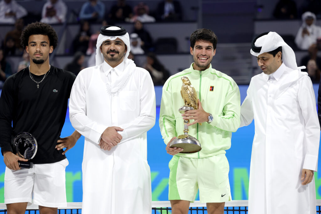 Carlos Alcaraz celebrates with the trophy after beating Arthur Fils in the 2026 Qatar Open final.