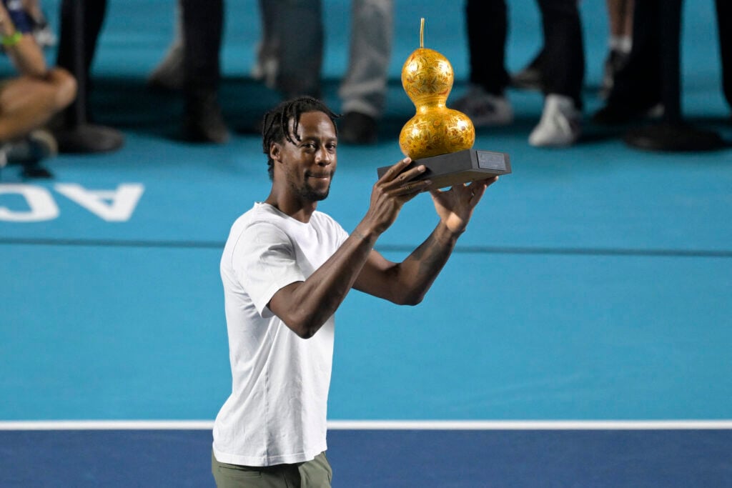 Gael Monfils holds a trophy in Acapulco.