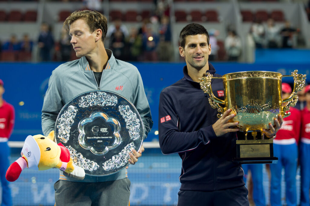 Novak Djokovic and Tomas Berdych hold their titles at the 2014 China Open.