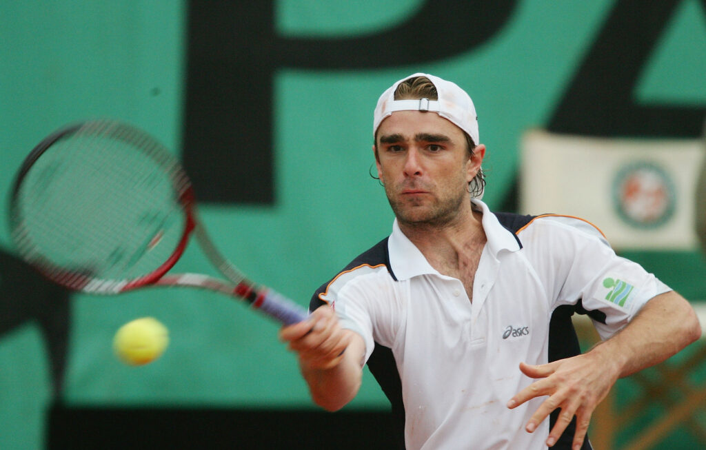 Olivier Mutis hitting a forehand in his match at the 2004 French Open.