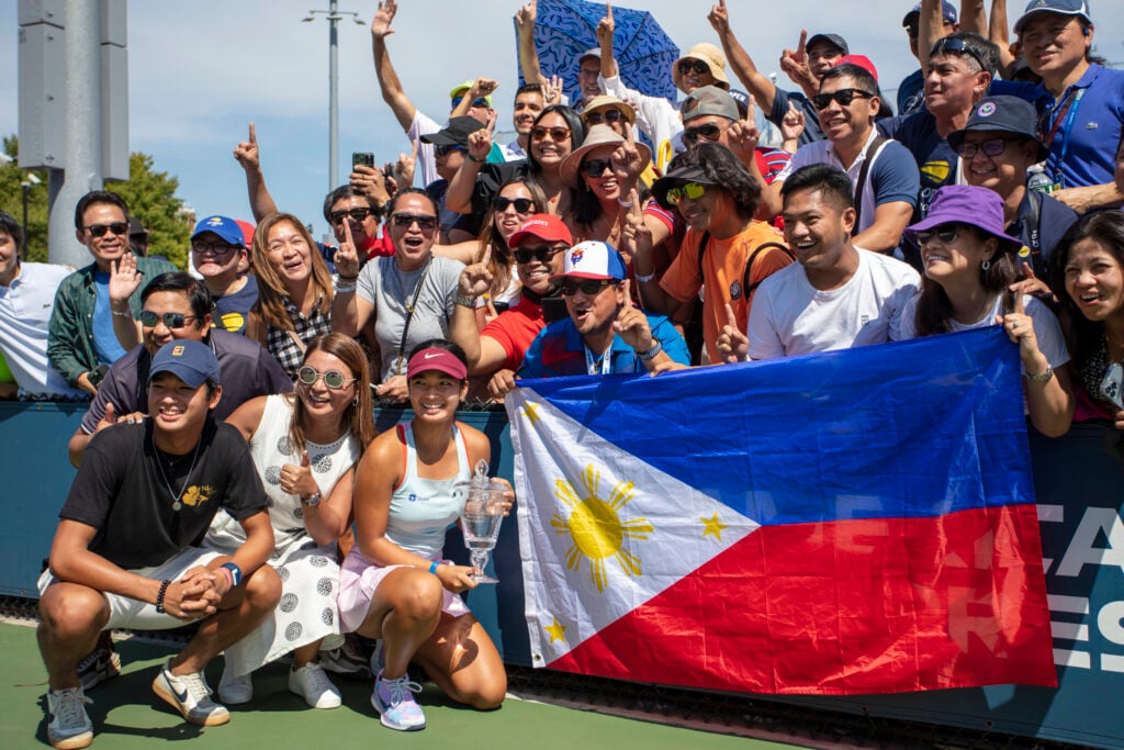 Alexandra Eala celebrates with her supporters after winning the 2022 US Open junior title.