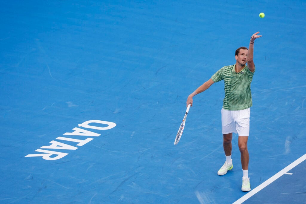 Daniil Medvedev hits a serve against Stefanos Tsitsipas at the 2026 Qatar Open.