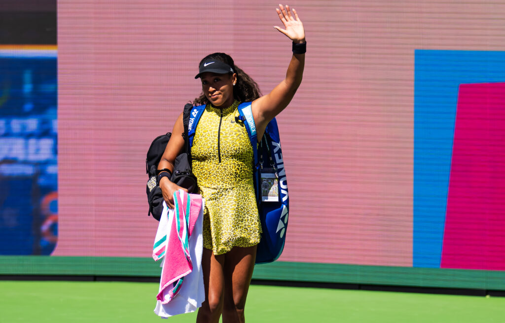 Naomi Osaka waves to the crowd after losing to Aryna Sabalenka at Indian Wells in 2026.