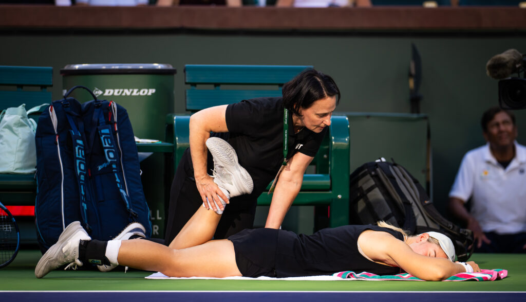 Sonay Kartal receiving a medical timeout during her match against Elena Rybakina at Indian Wells in 2026.