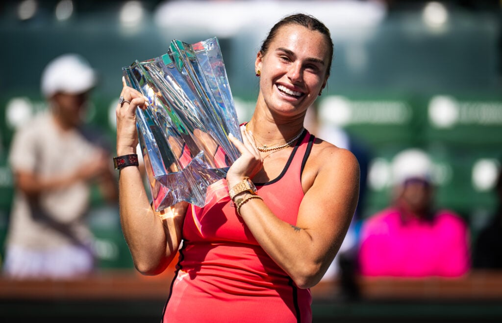Aryna Sabalenka poses with the Indian Wells trophy after winning the 2026 title.