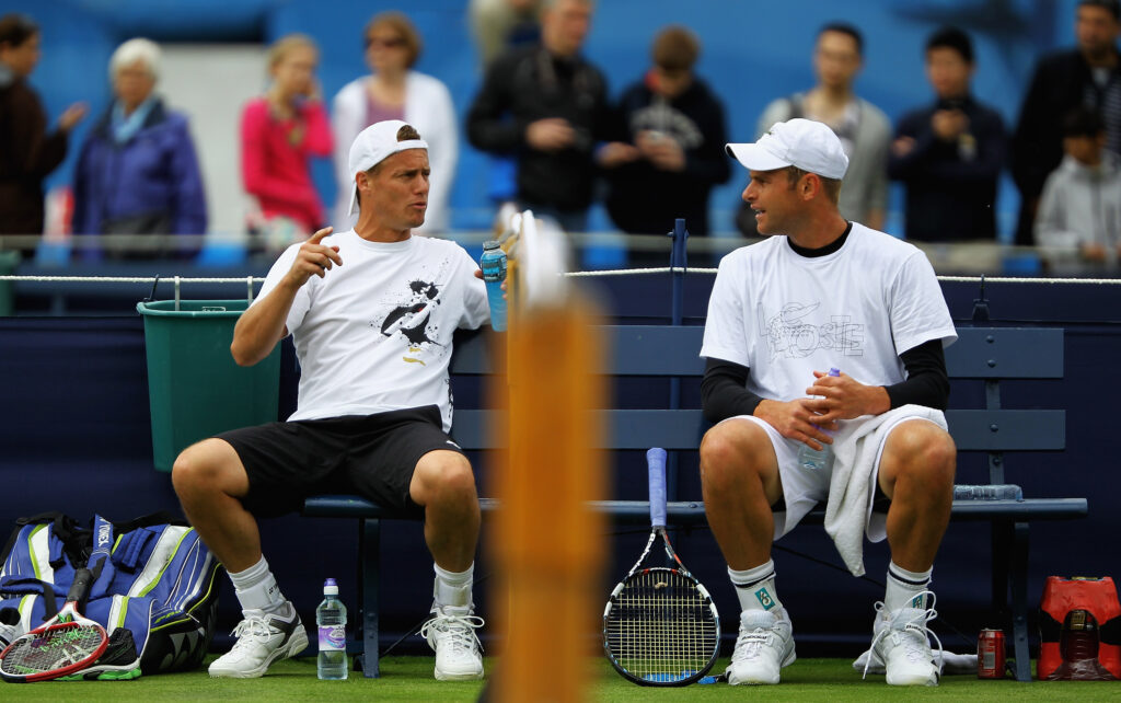 Lleyton Hewitt and Andy Roddick speak in 2012.