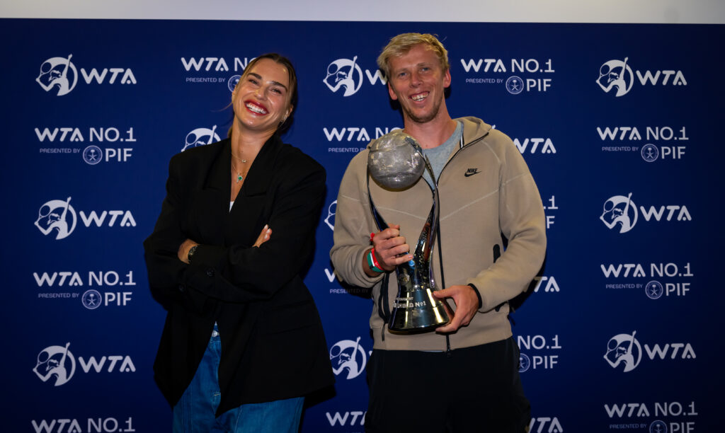 Aryna Sabalenka and hitting partner Andrei Vasilevski pose with the Chris Evert World No.1 trophy at the 2024 WTA Finals in Riyadh, Saudi Arabia.