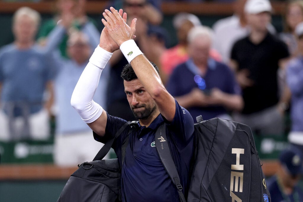 Novak Djokovic applauds the crowd as he leaves the court following his defeat to Jack Draper at Indian Wells in 2026.