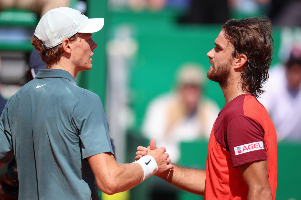Jannik Sinner and Tomas Machac shake hands.