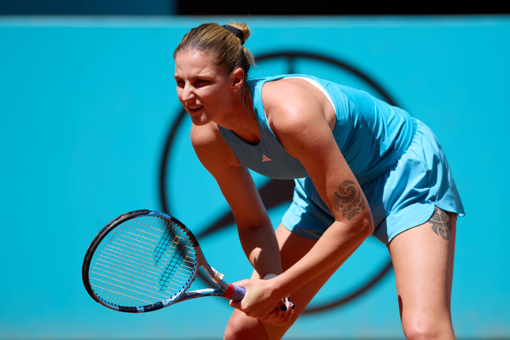 Karolina Pliskova looks on.