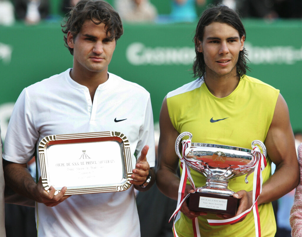 Roger Federer and Rafael Nadal pose with their respective trophies at the 2006 Monte Carlo Masters.
