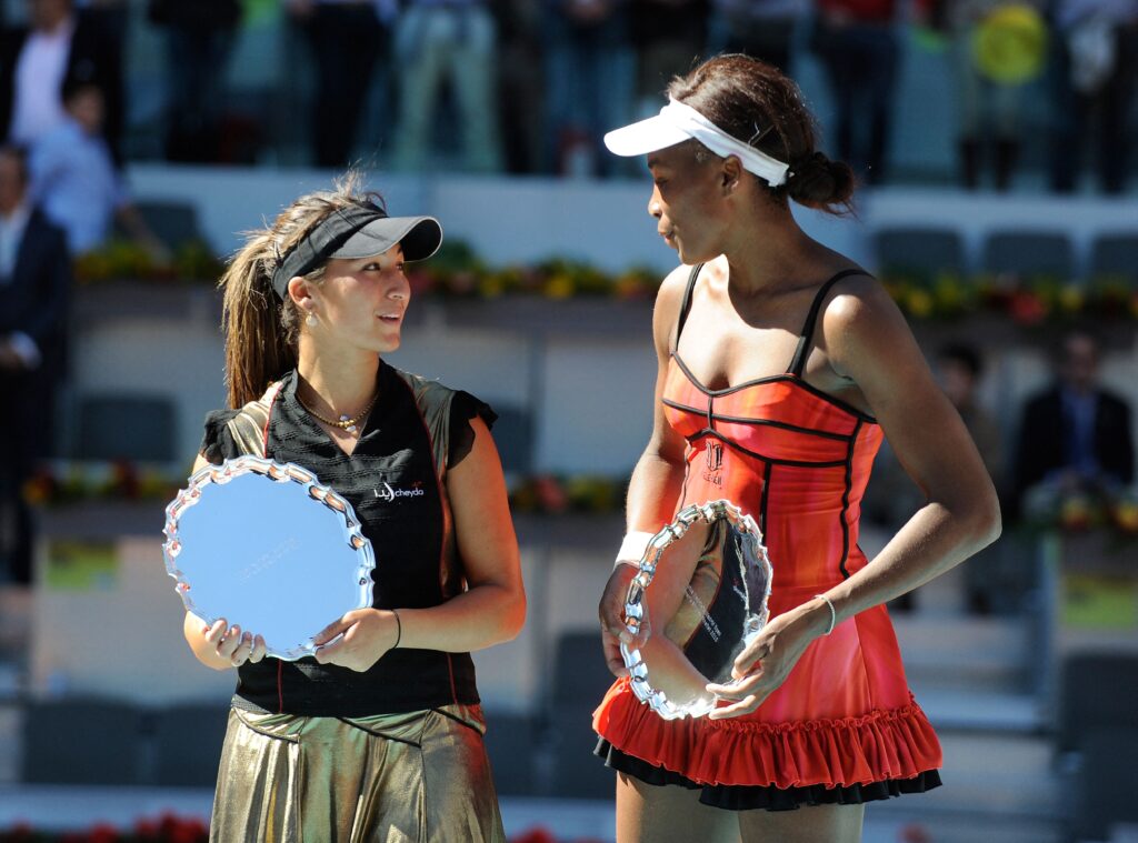 Aravane Rezai and Venus Williams pose with the Madrid Open trophies after the 2010 final.