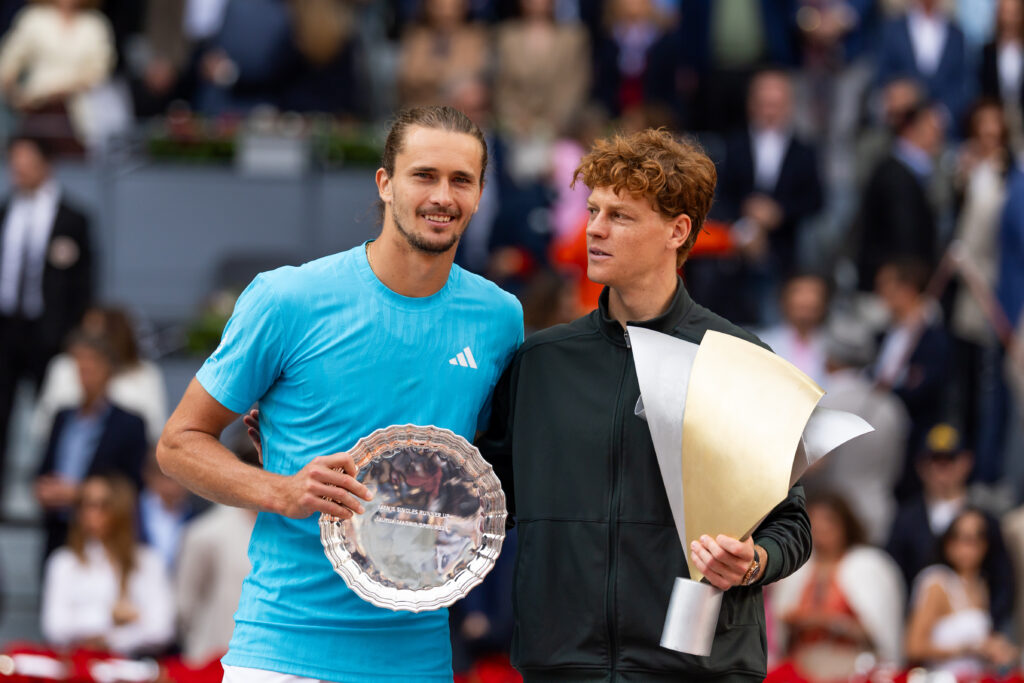 Jannik Sinner and Alexander Zverev hold their trophies at the Madrid Open.
